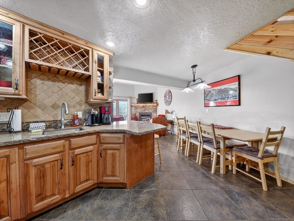 Your spacious kitchen flows seamlessly into the dining area, where warm wood cabinets and granite counters create the perfect gathering space.