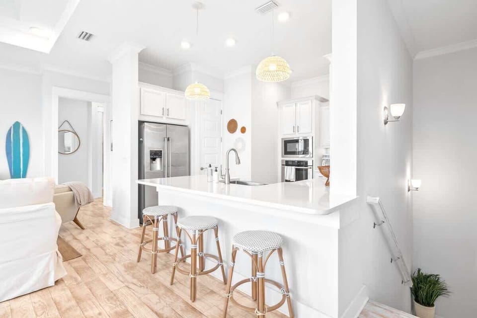 3 barstools at the large kitchen island.