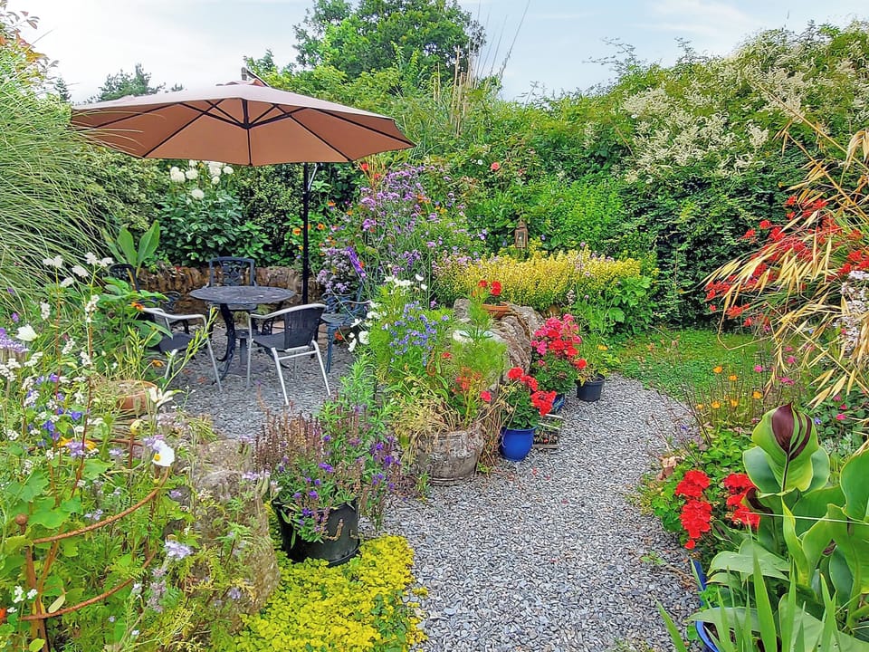 The round garden is a perfect spot for relaxing at any time of day | Little Forda, Chillaton, near Tavistock