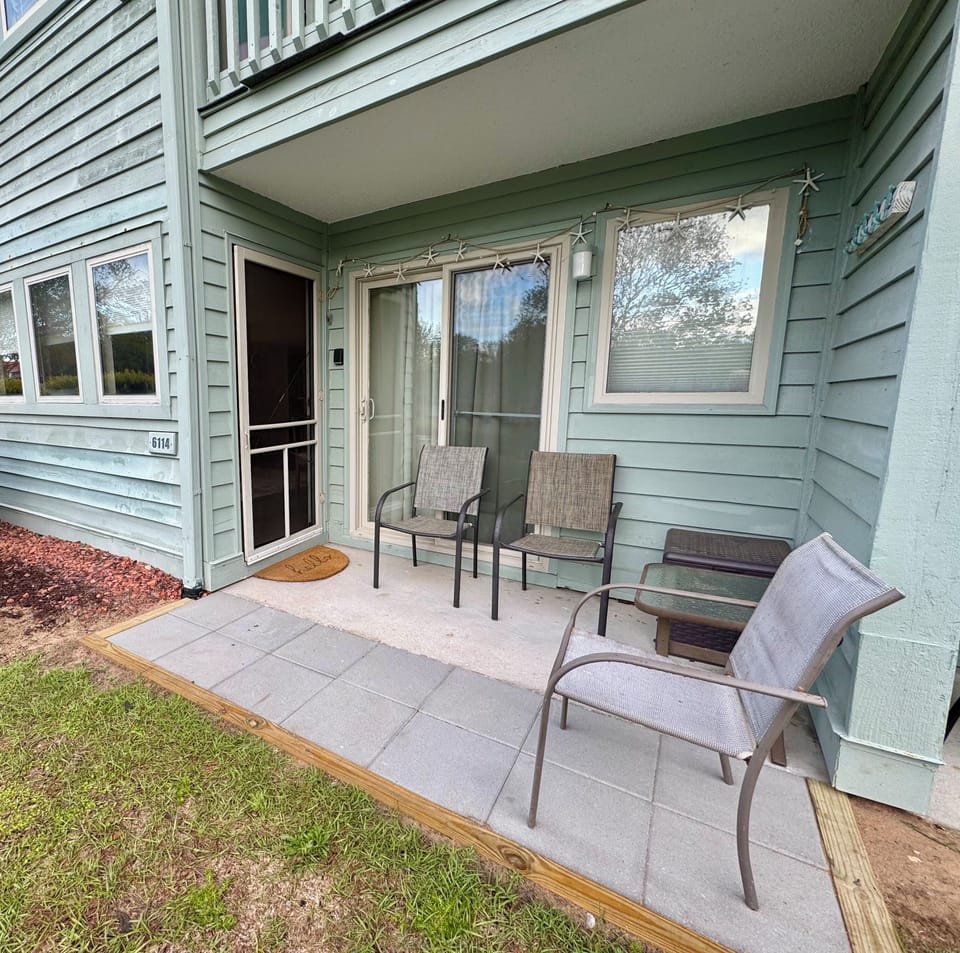 Private patio with views of a pond, swans, ducks, and nearby pickleball courts.