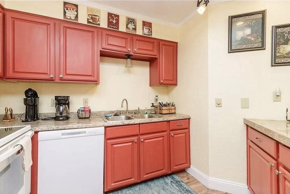 Enjoy creating culinary memories in your fully equipped kitchen with charming red cabinets, granite counters, and thoughtful coffee-themed touches.