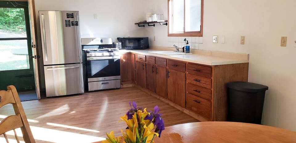 The kitchen features new stainless steel appliances and is fully stocked with everything you may need, dishes, pots/pans, pizza cutter, toaster, microwave and more.