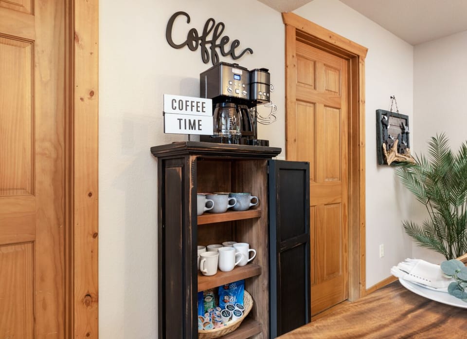 Start your day with a freshly brewed cup of coffee in this charming corner, complete with a modern coffee machine and a cozy, rustic setting.  Coffee Bar Complete With K Cups, Ground Coffee, Creamer, Sugar, Steavia, Tea Bags, and Kettle.  Mmm delicious!