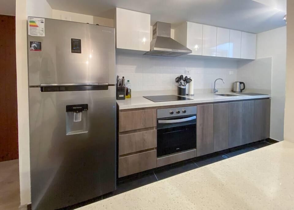 Modern fully-stocked kitchen with new appliances.