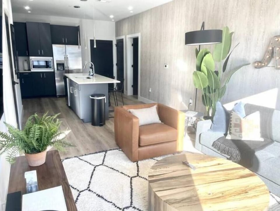 Bright living room-comfortable seating, smart TV, designer decor, queen sleeper