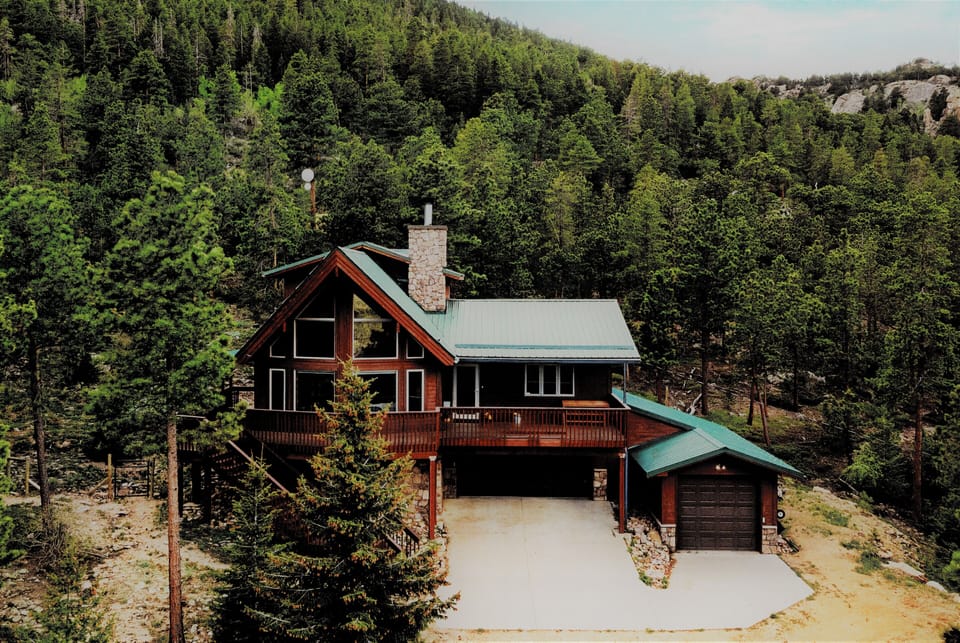 Custom mountain home on 7 private acres backing National Forest