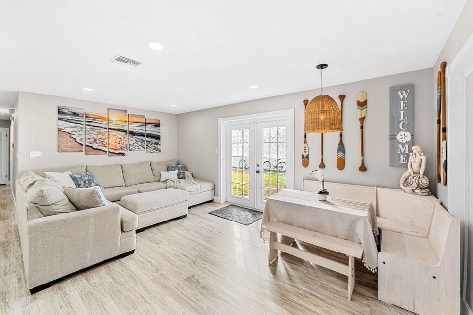 Bright & spacious living room with comfy couch and access to the backyard .