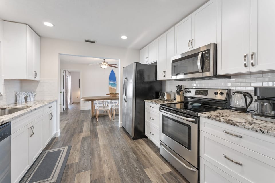 Cook with ease in a modern kitchen featuring sleek stainless steel appliances for a seamless culinary experience