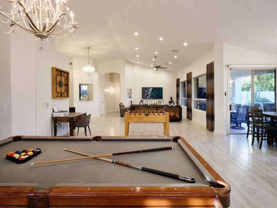 Open concept living area with foosball, pool table, and work station.