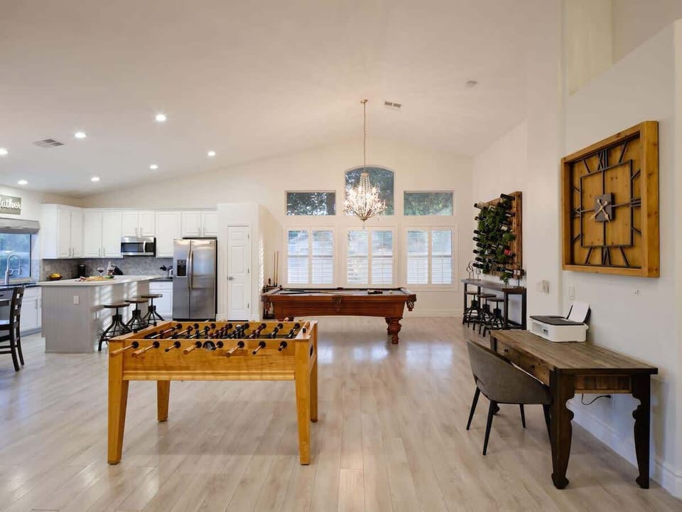Open concept living area with foosball, pool table, and work station.