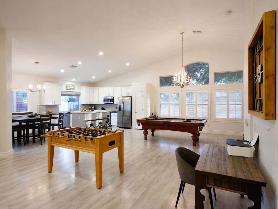Open concept living area with foosball, pool table, and work station.
