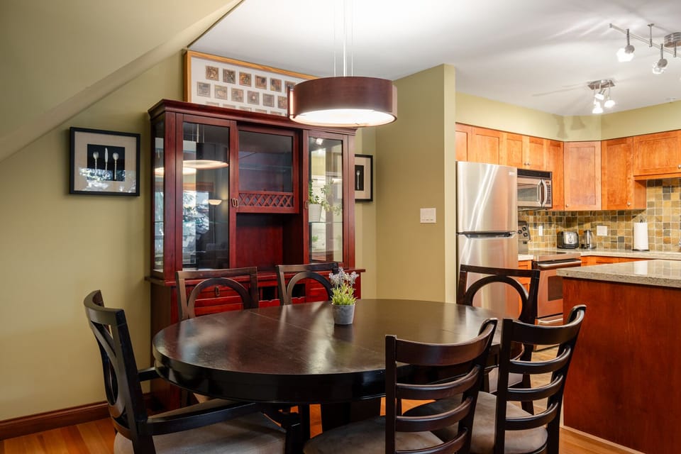 Enjoy shared meals at the wooden dining table with seating for the whole group.