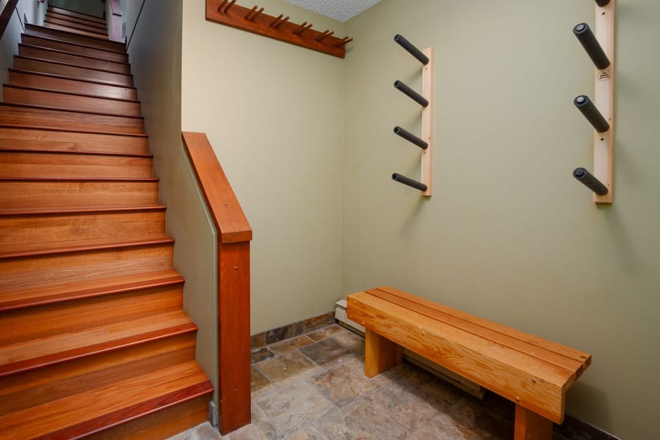 A tiled entryway with ample space for coats, boots, and gear.