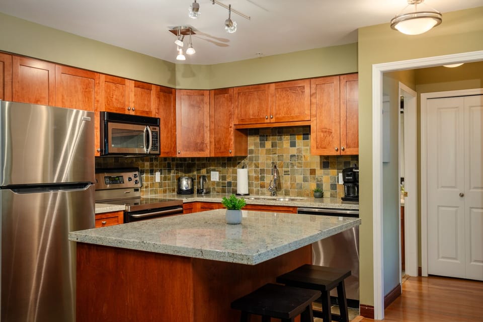 Prepare meals with ease in the fully equipped kitchen with stainless steel appliances.