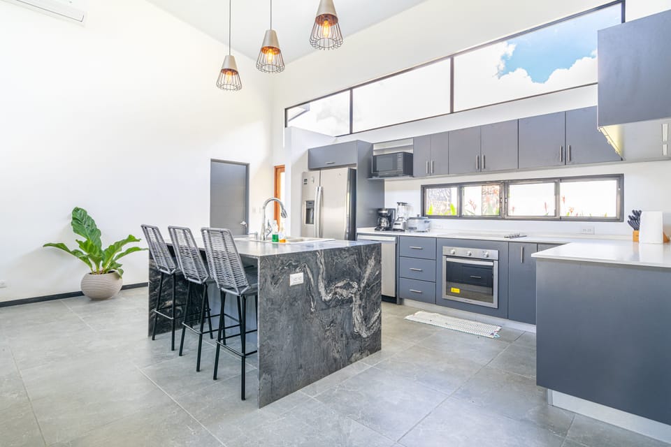 Roomy kitchen with a central island and modern finishes.