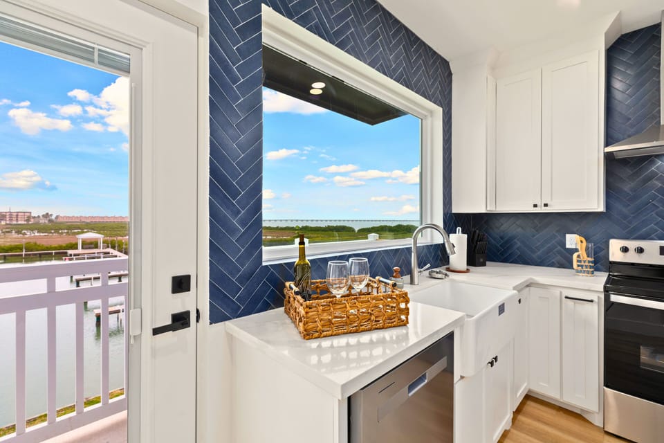 Enjoy cooking in a beautifully designed kitchen with a spacious island, modern finishes, and all the cookware and essentials to make you feel right at home.