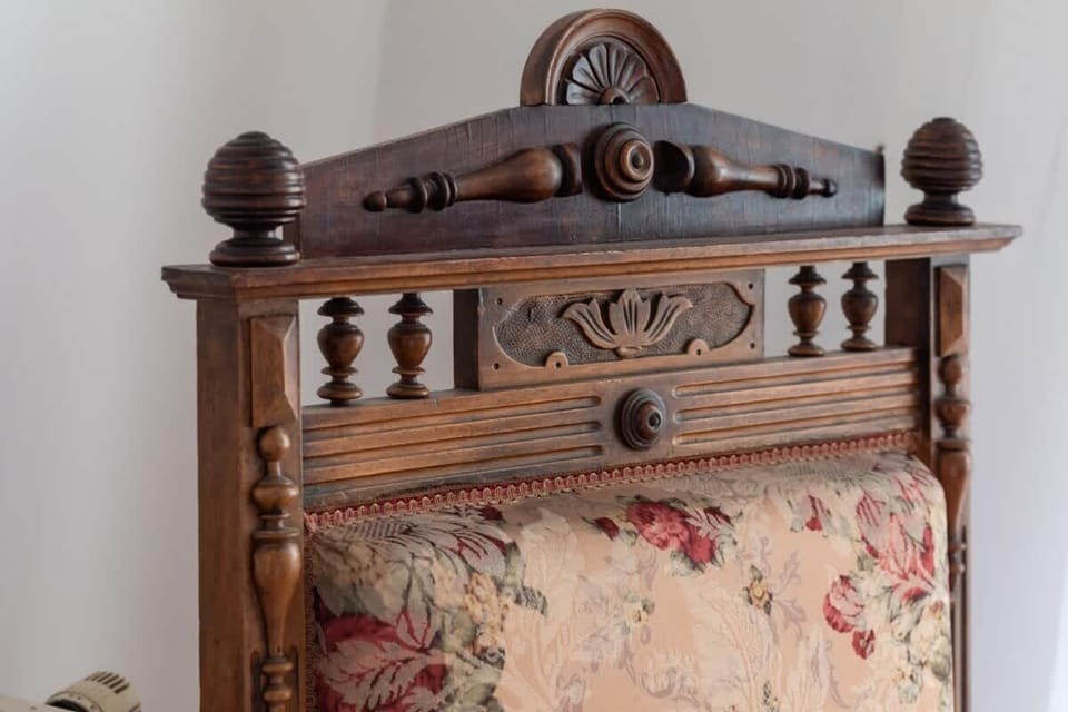 A detailed look at an antique wooden furniture piece with ornate carvings, adding a touch of vintage charm.

