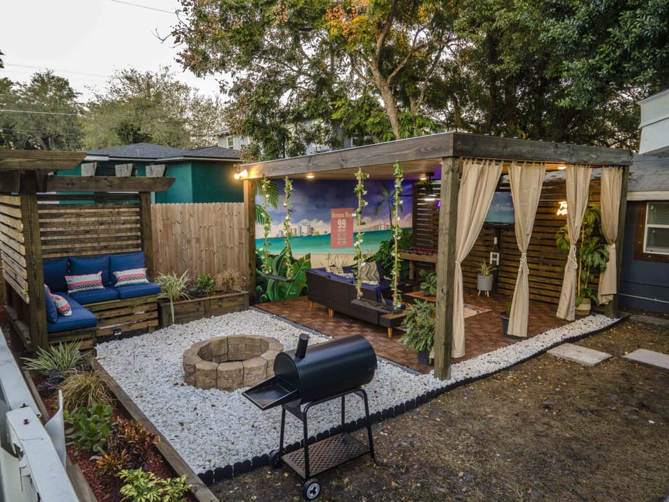 Outdoor living space full with seating, fire pit, Grill, Smart TV, etc.