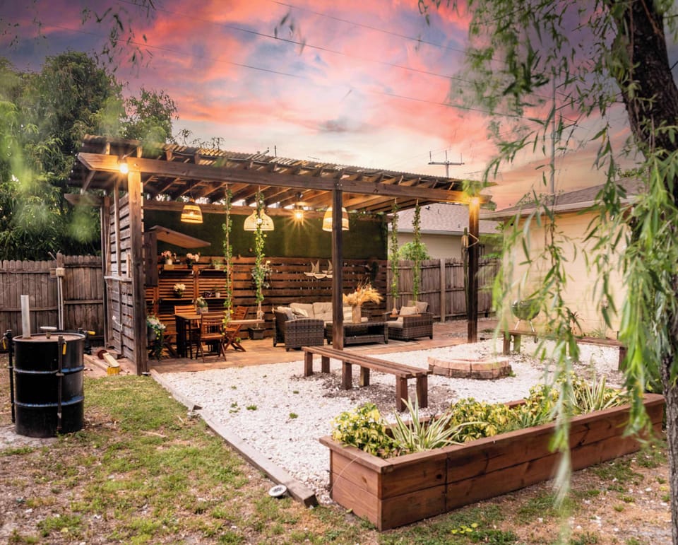 Outdoor living space equipped with Smart TV, Outdoor Grill, Smoker, dining area, appropriate lighting and fans
