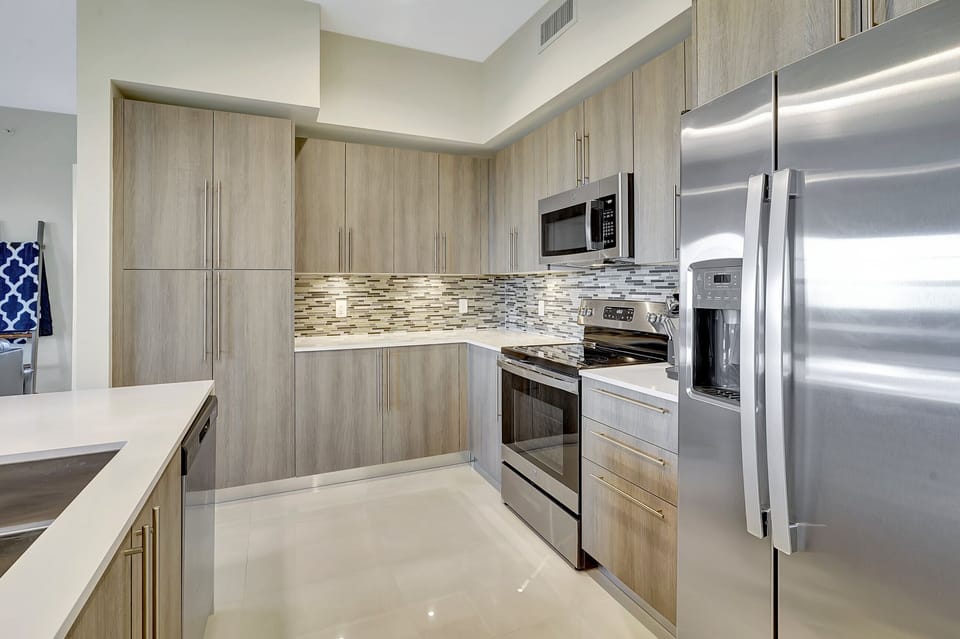 The kitchen is adorned with natural light and is fully equipped for seasonal rentals