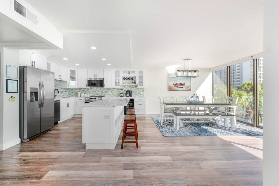 Dine at the table for 9 supplemented by barstool seating for 4 at the kitchen island.