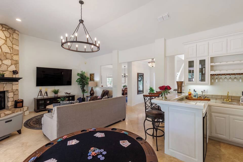 Living room with bar and poker table. This  space opens to the pool and patio