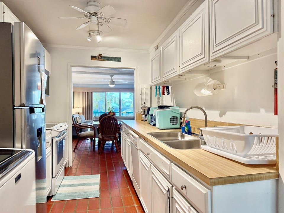 Kitchen with dishwasher, stove and microwave/convection oven combo.