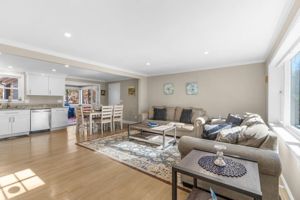 Open floor plan leading from the living room to dining table and kitchen area! There is an additional sunroom living space off the kitchen, overlooking the patio & backyard.