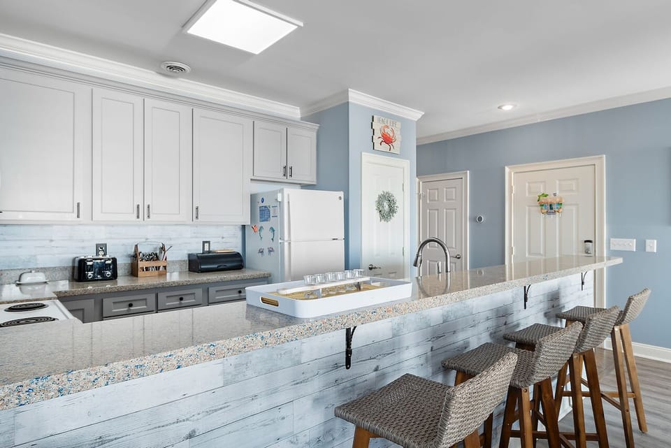 Your gourmet kitchen awaits with granite counters, breakfast bar seating, and everything needed for memorable meals together.
