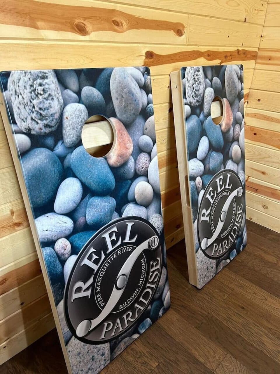 Challenge your friends to a fun game of cornhole, with this custom `Reel Paradise` set for friendly competition.