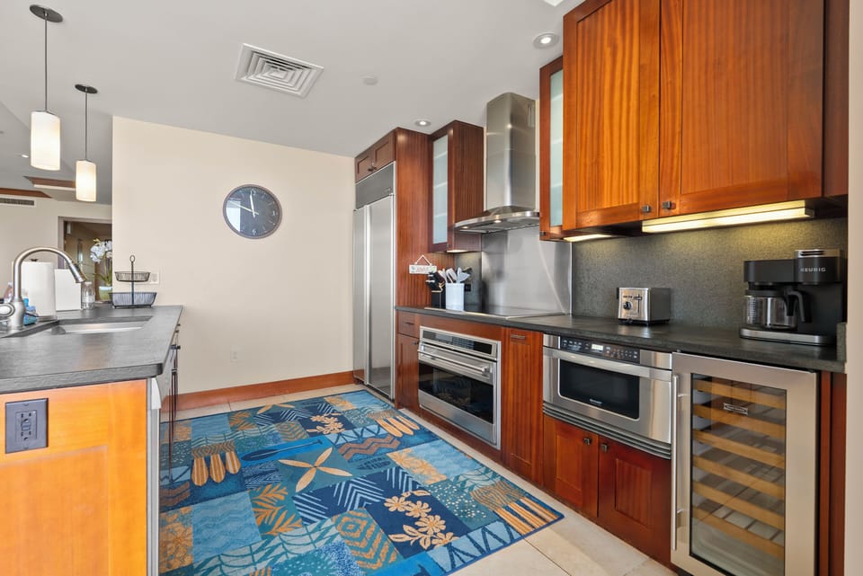 Dark counters and full-size stainless, room to spread out a whole meal's prep.