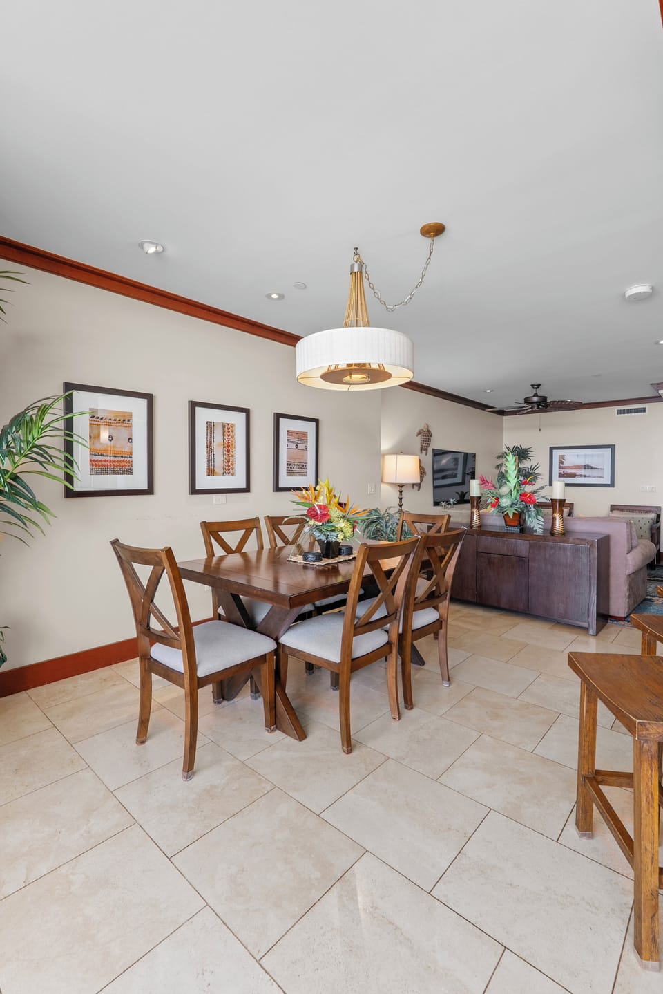 Linger at the dining table with the living room open just beyond.