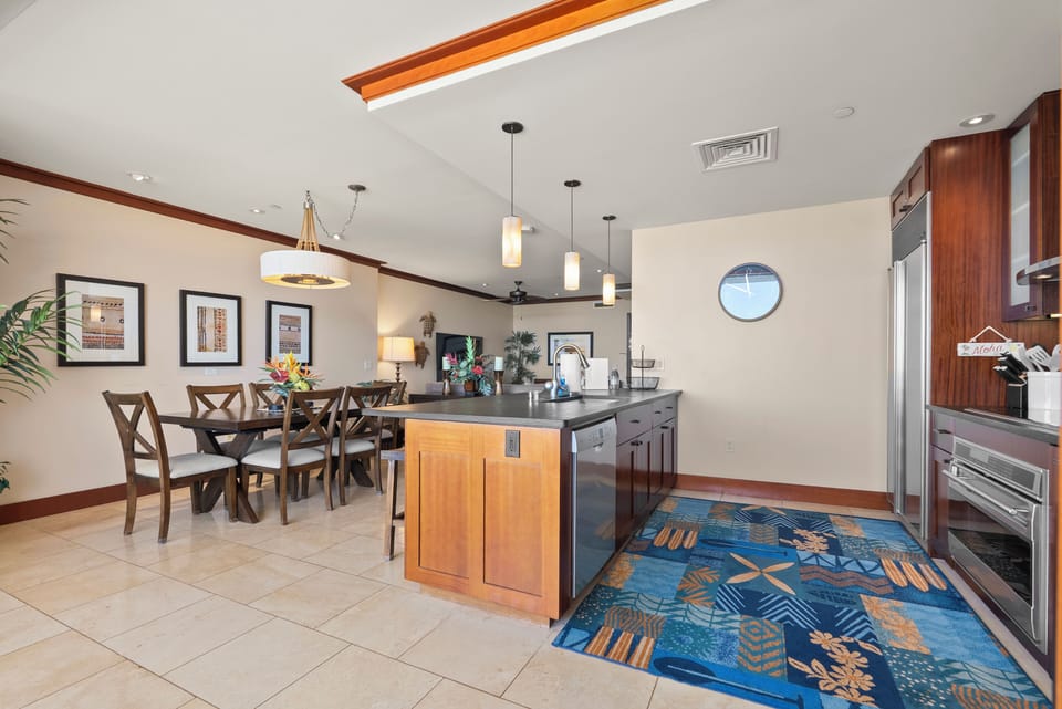 Gather at the dining table with the kitchen island an easy reach behind.