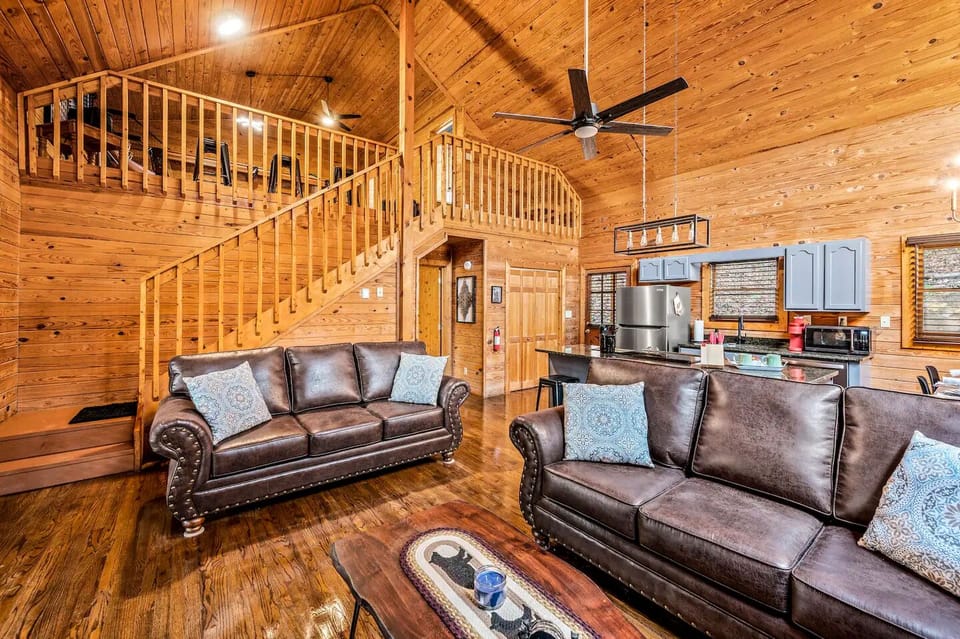 Living room with stairs leading to Game Room