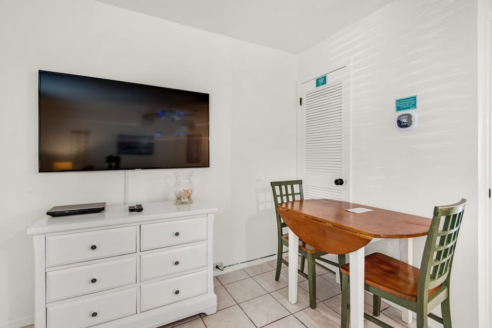 Flat screen TV next to dining table