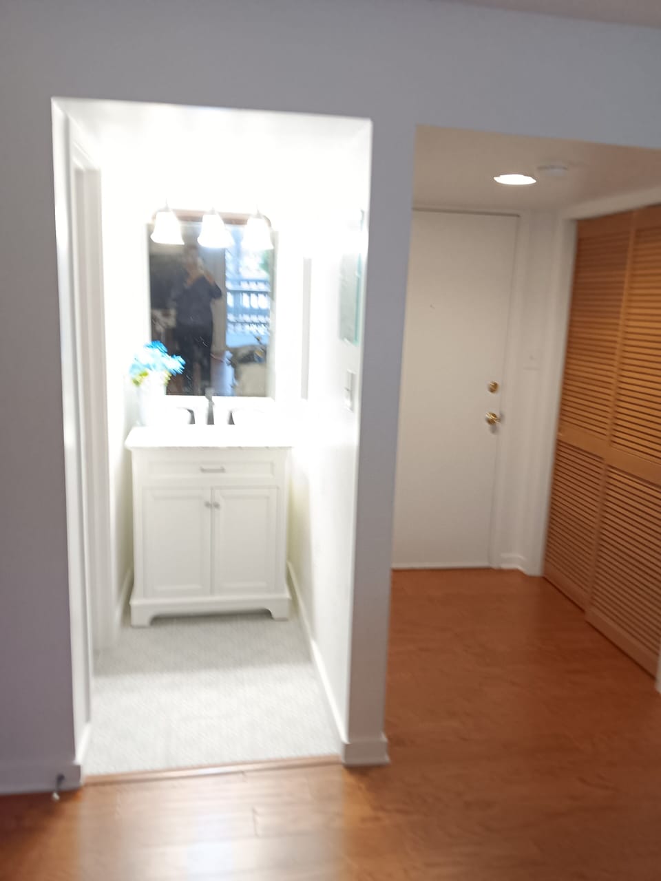 View of sink and front door with peep hole and double lock