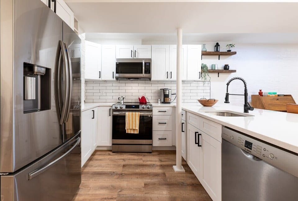 Kitchen with stainless steel appliances including a refrigerator, dishwasher, oven, stove, microwave, coffee maker and provided essentials. 