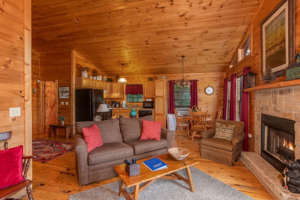 Open concept living space with fireplace at A View for You, a 1 bedroom cabin rental located in Pigeon Forge
