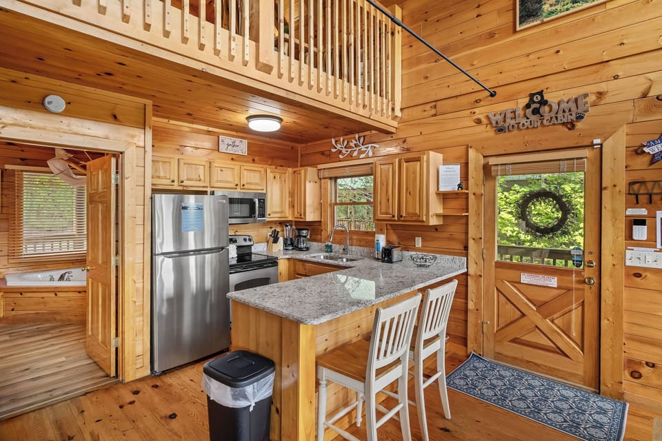 Kitchen with counter and bar chairs