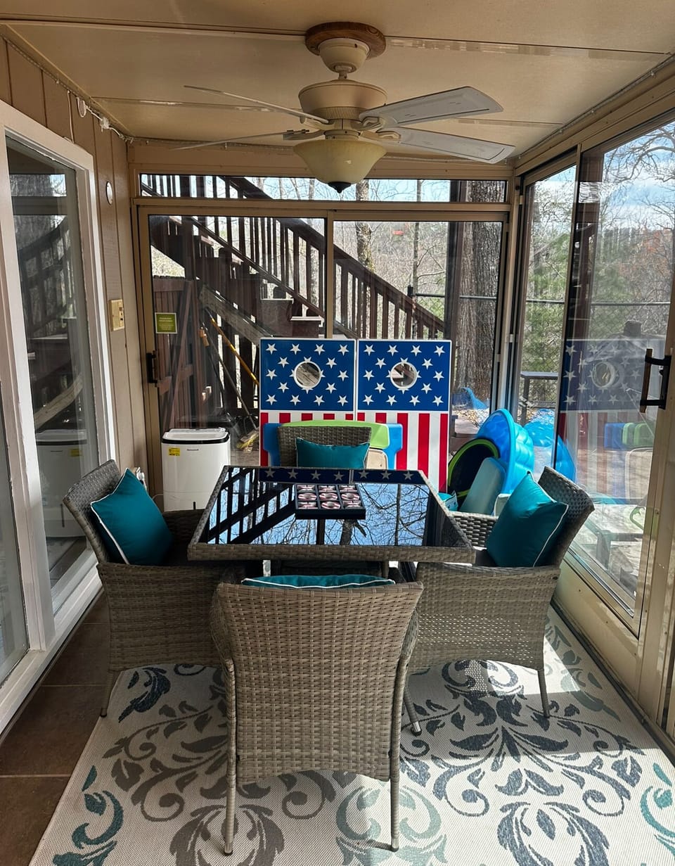 Seating area on screened in porch at Buena Vista Getaway, 3 bedroom cabin rental located in Gatlinburg