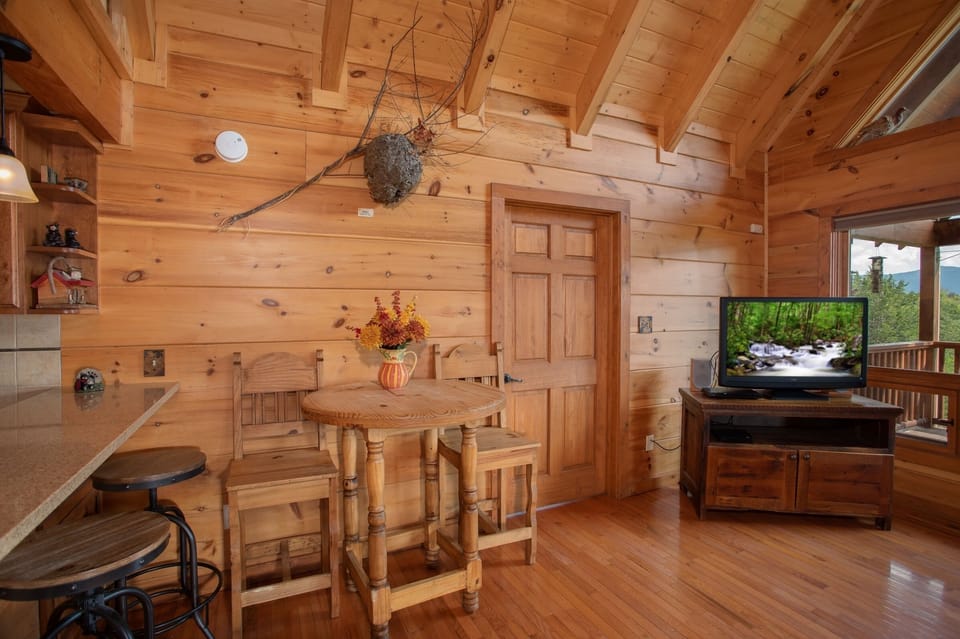 Dining space shared with the living room at Cedar Creeks, a 2-bedroom cabin rental located near Douglas Lake