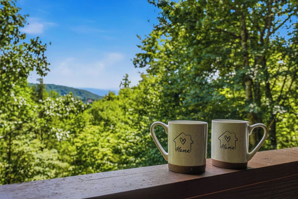 Start mornings with fresh mountain air and stunning views framed by lush greenery—your peaceful escape awaits from this scenic outdoor space.