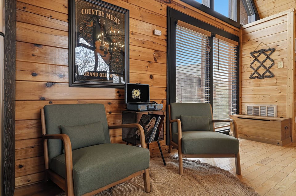 Sink into these cozy armchairs and enjoy the rustic charm of warm wood walls, vintage country music decor, and peaceful natural light filtering through.