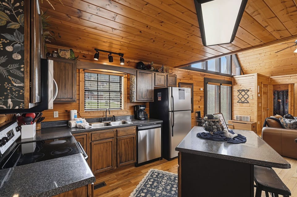 Your fully equipped kitchen features warm wood cabinets, granite countertops, and stainless steel appliances—perfect for preparing memorable meals during your stay.