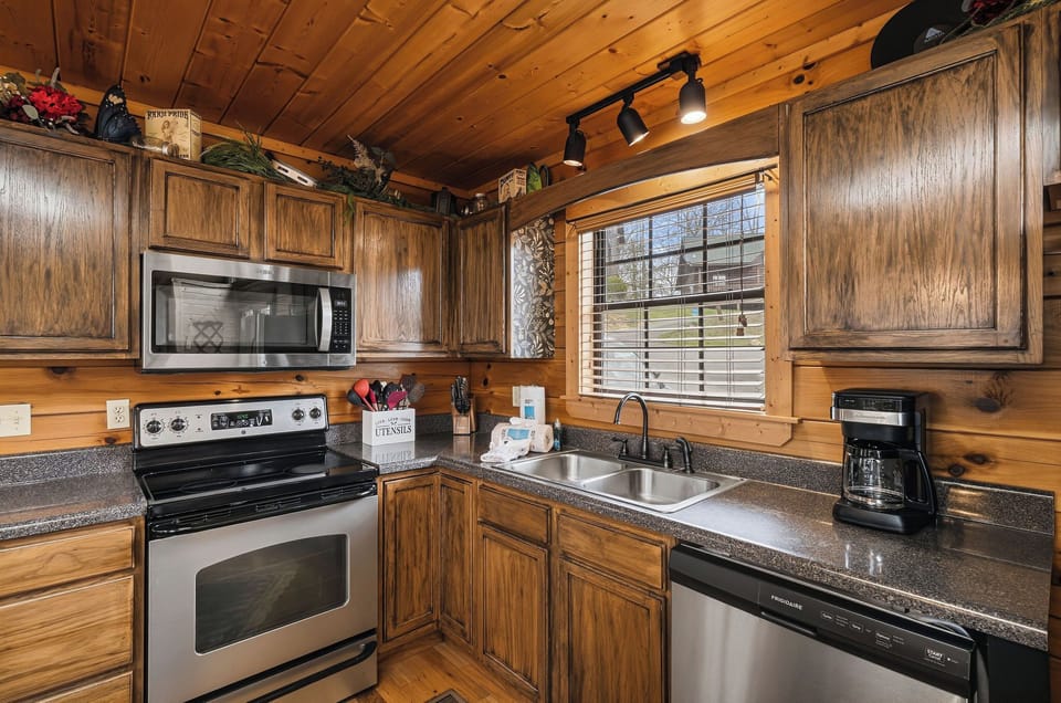 Your fully equipped kitchen blends rustic charm with modern convenience—rich wood cabinets, granite counters, and quality appliances await your culinary adventures.