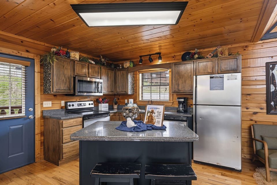 Gather around your fully-equipped cabin kitchen, where rustic wood meets modern convenience for memorable meal prep together.