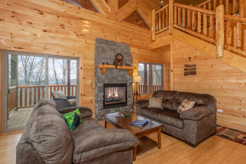 Living room with see through fireplace at Happy Bear's Hideaway, a 2 bedroom cabin rental located in Gatlinburg