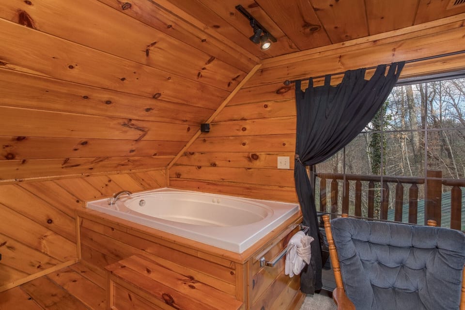 Jacuzzi in the king loft bedroom at Hidden Pleasure, a 1-bedroom cabin rental located in Gatlinburg
