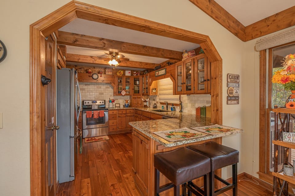 Breakfast bar seating for two and kitchen with stainless appliances at Lazy Bear Retreat, a 4 bedroom cabin rental located in Pigeon Forge