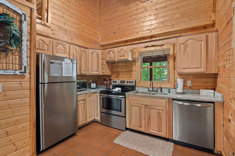 full size appliances and sink with window for natural light and view